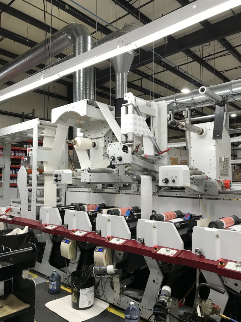 printing press showing tri-panel label being printed 
