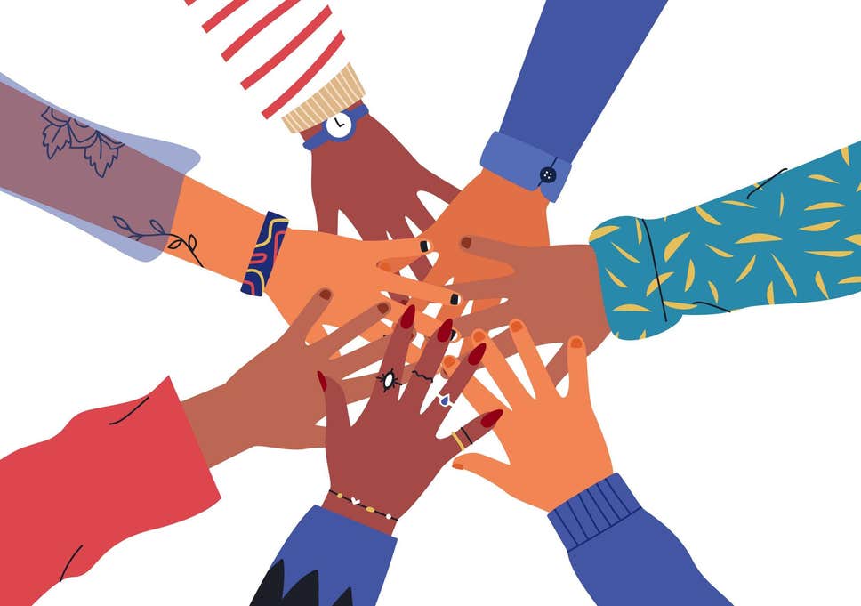 international women's day image of women's hands in a team group 